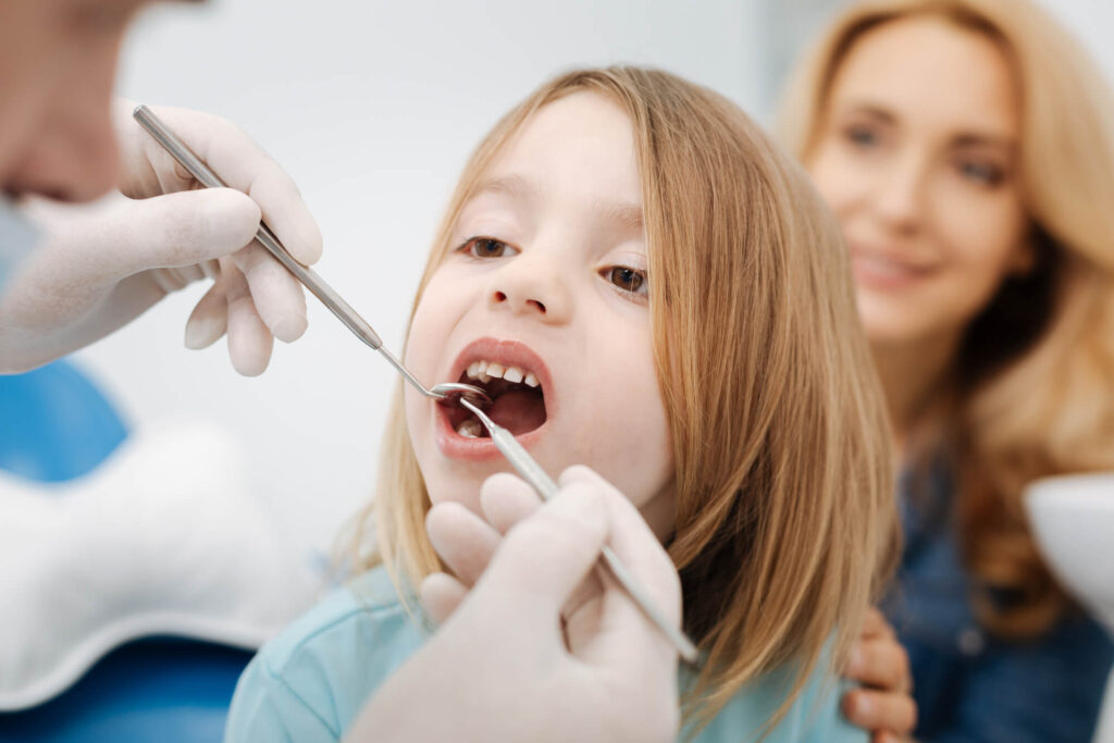 an expert in somerset family dentistry checking a pediatric patient's teeth